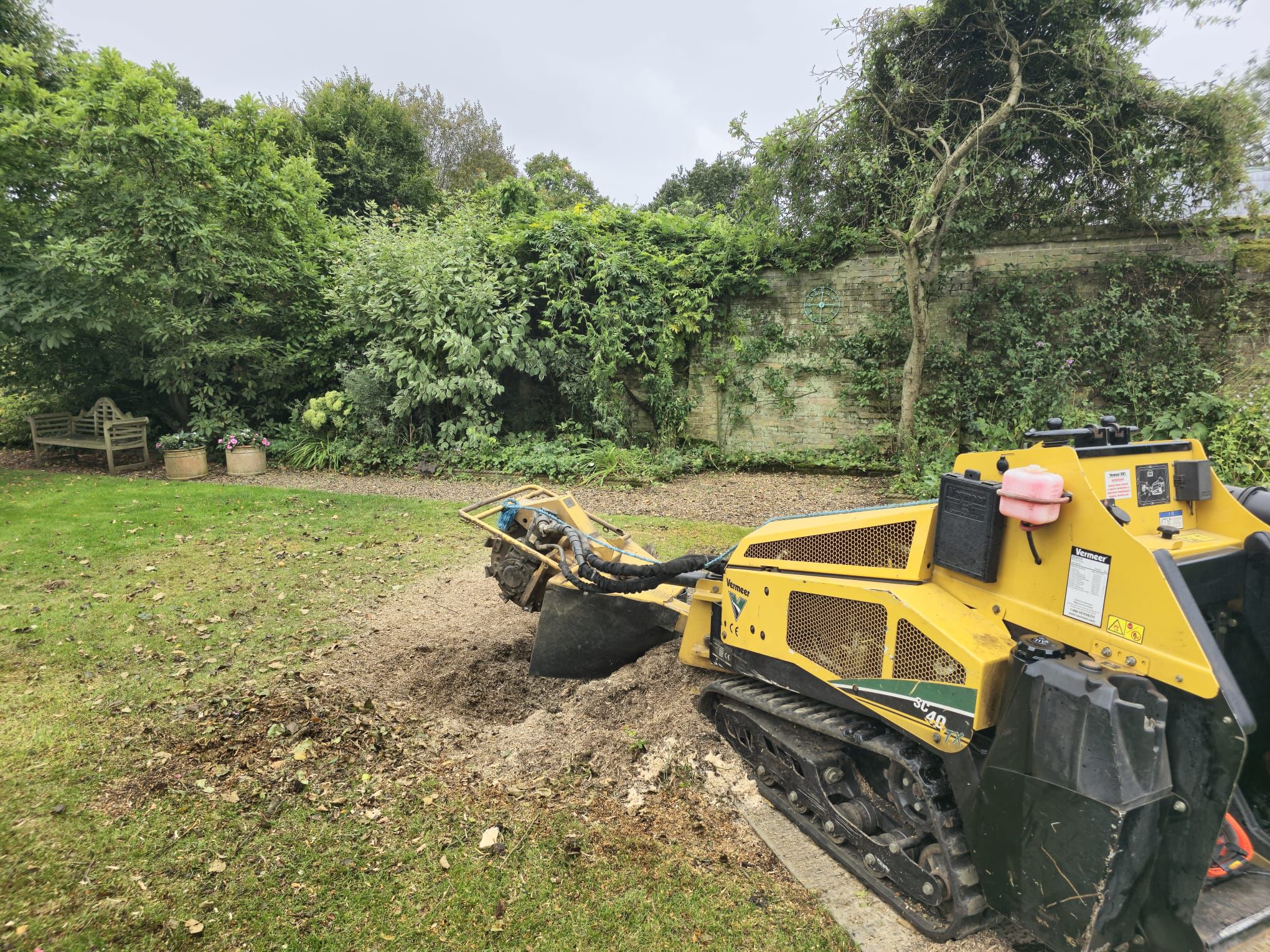 Professional stump grinding operation showing specialist equipment in action